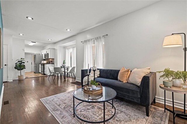 4421 Tracy Ave, Kansas City, MO 64110 - living area featuring hardwood / wood-style floors, recessed lighting, and baseboards