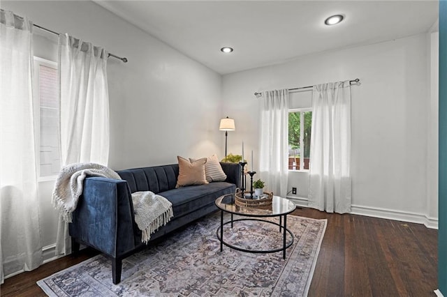 4421 Tracy Ave, Kansas City, MO 64110 - living room with wood finished floors, baseboards, and recessed lighting
