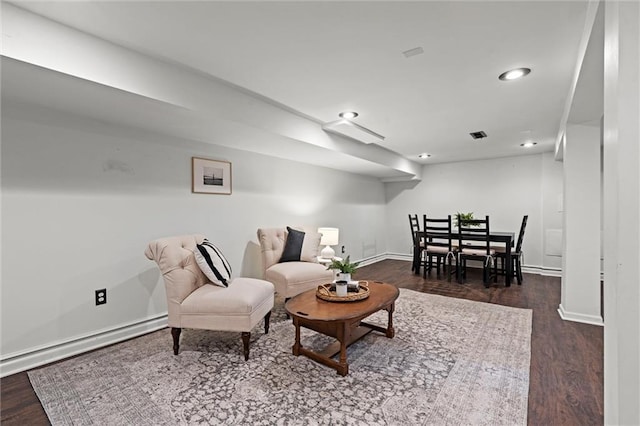 4421 Tracy Ave, Kansas City, MO 64110 - living area with dark wood-style flooring, recessed lighting, baseboards, and a baseboard radiator