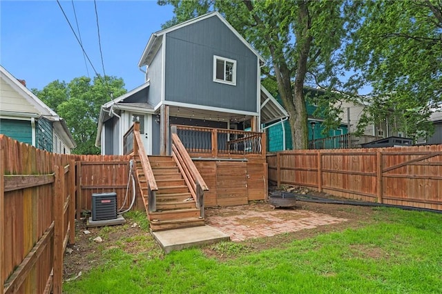 4421 Tracy Ave, Kansas City, MO 64110 - rear view of property with central air condition unit and stairs