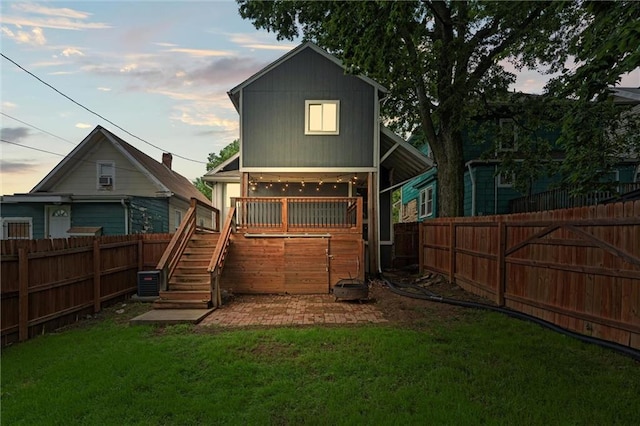 4421 Tracy Ave, Kansas City, MO 64110 - back of house at dusk with stairway and cooling unit