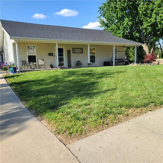 1525 Duncan St, Saint Joseph, MO 64503 - view of front of house with a front yard, covered porch, and roof with shingles
