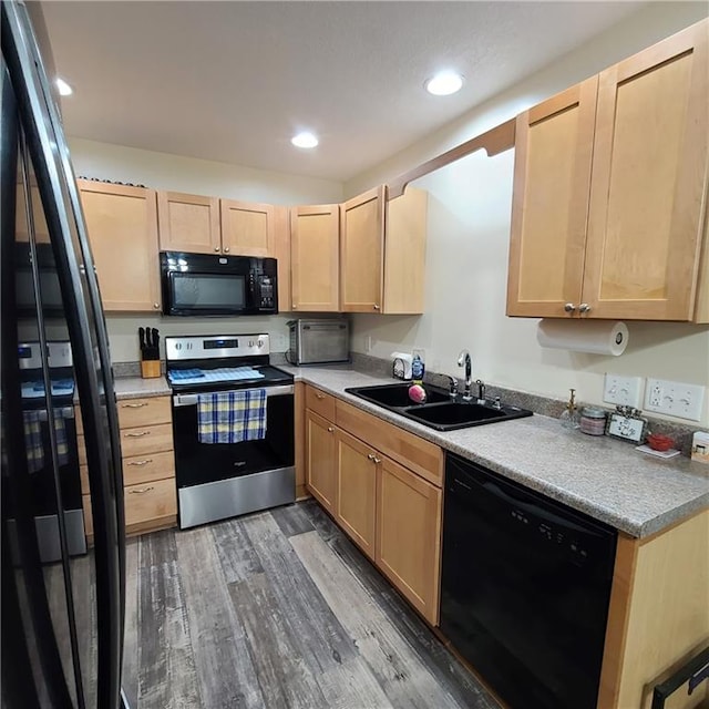 1525 Duncan St, Saint Joseph, MO 64503 - kitchen with black appliances, a sink, light brown cabinetry, wood finished floors, and light countertops