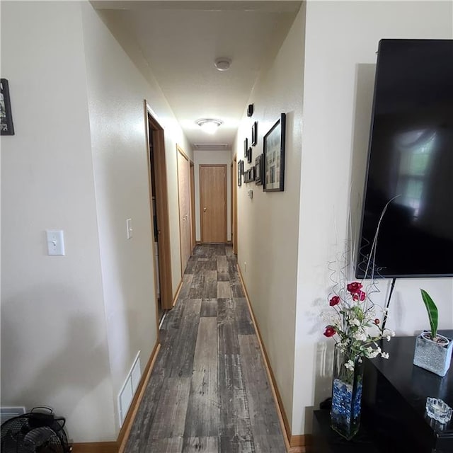1525 Duncan St, Saint Joseph, MO 64503 - hallway featuring dark wood-type flooring and baseboards