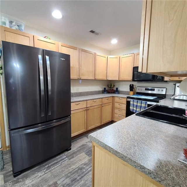 1525 Duncan St, Saint Joseph, MO 64503 - kitchen with appliances with stainless steel finishes, light brown cabinetry, a sink, wood finished floors, and recessed lighting