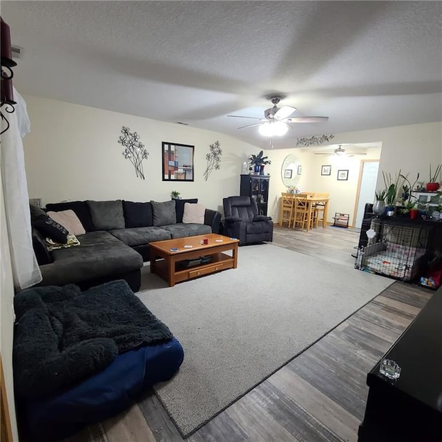 1525 Duncan St, Saint Joseph, MO 64503 - living room featuring wood finished floors, a ceiling fan, and a textured ceiling