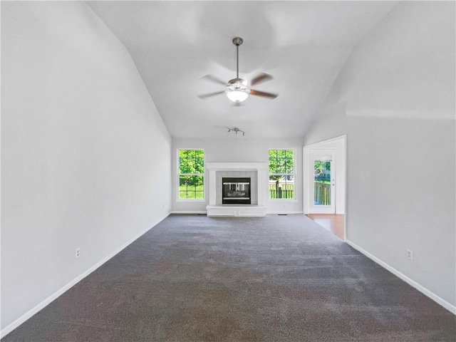 18100 E 11th Terrace Ct N, Independence, MO 64056 - unfurnished living room featuring ceiling fan, carpet flooring, baseboards, a glass covered fireplace, and high vaulted ceiling
