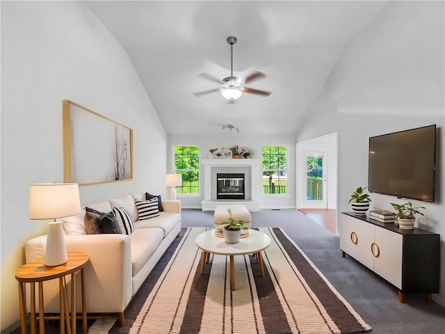 18100 E 11th Terrace Ct N, Independence, MO 64056 - living area with ceiling fan, a glass covered fireplace, dark colored carpet, and high vaulted ceiling