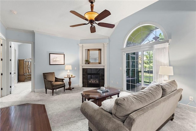 16904 S Bradley Dr, Olathe, KS 66062 - carpeted living room featuring a fireplace, a ceiling fan, crown molding, and lofted ceiling