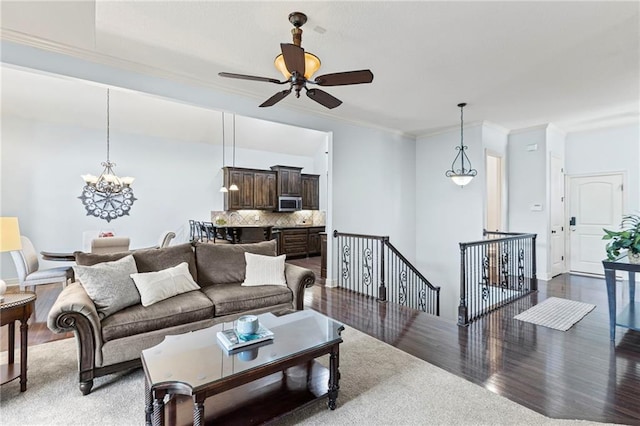 16904 S Bradley Dr, Olathe, KS 66062 - living room with wood finished floors, a chandelier, a ceiling fan, and crown molding