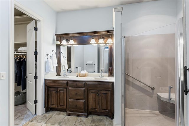 16904 S Bradley Dr, Olathe, KS 66062 - bathroom with double vanity, a stall shower, and a spacious closet