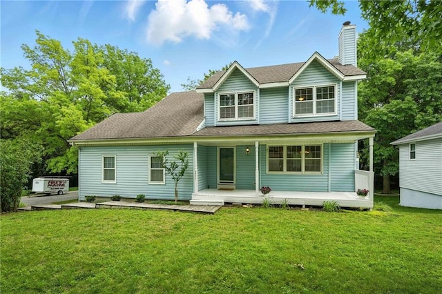 8025 Woodstone St, Lenexa, KS 66219 - back of house with a chimney, covered porch, a lawn, and roof with shingles