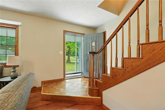 8025 Woodstone St, Lenexa, KS 66219 - foyer with stairs and a textured ceiling