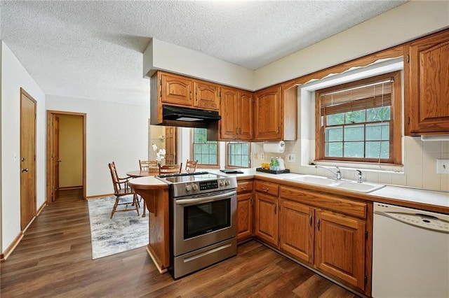 8025 Woodstone St, Lenexa, KS 66219 - kitchen featuring white dishwasher, stainless steel electric stove, brown cabinets, light countertops, and dark wood-type flooring