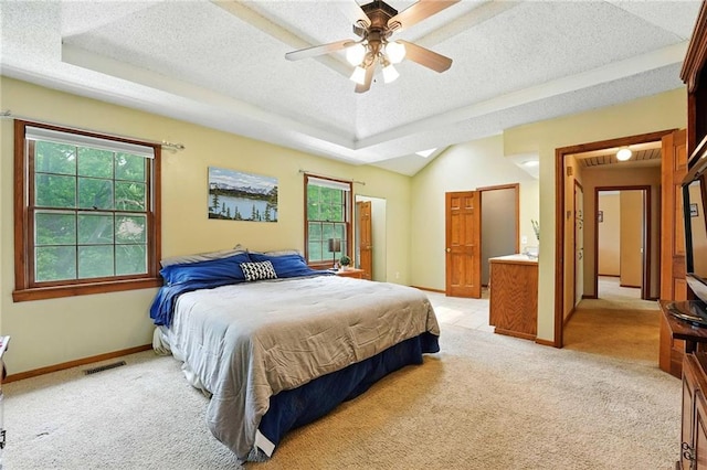 8025 Woodstone St, Lenexa, KS 66219 - bedroom with light colored carpet, a textured ceiling, a raised ceiling, and ceiling fan