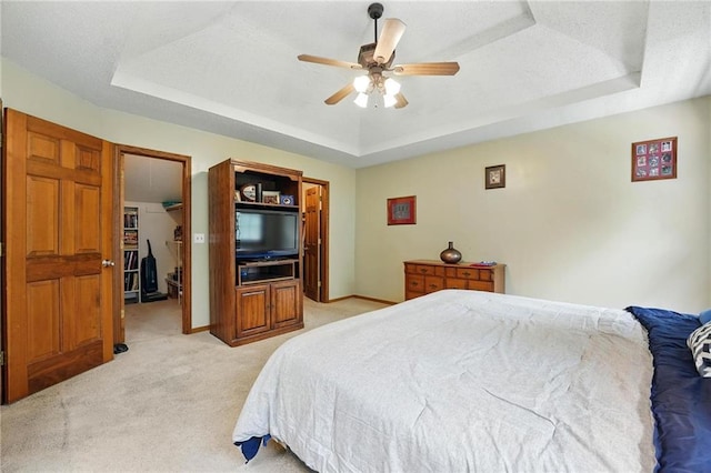 8025 Woodstone St, Lenexa, KS 66219 - bedroom featuring a tray ceiling, light carpet, and ceiling fan