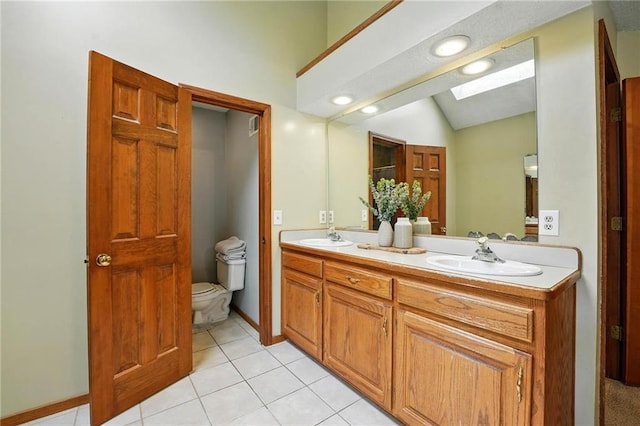 8025 Woodstone St, Lenexa, KS 66219 - bathroom with a skylight, double vanity, tile patterned floors, and lofted ceiling