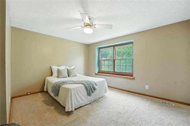 8025 Woodstone St, Lenexa, KS 66219 - carpeted bedroom with a textured ceiling and a ceiling fan