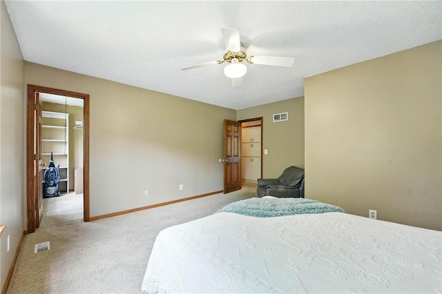 8025 Woodstone St, Lenexa, KS 66219 - bedroom featuring a walk in closet, light carpet, a ceiling fan, and a closet