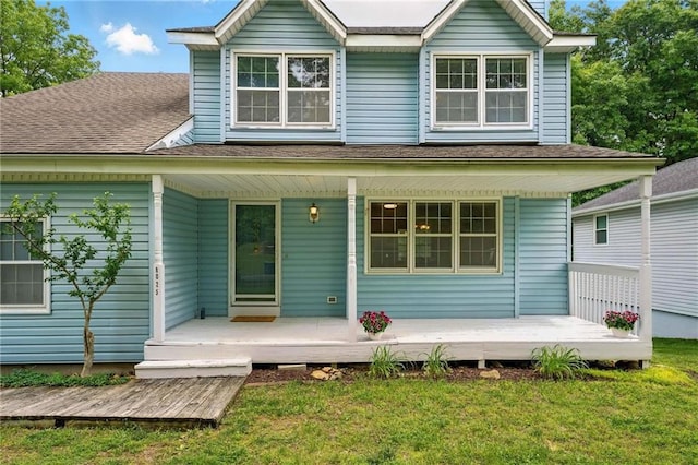 8025 Woodstone St, Lenexa, KS 66219 - rear view of property with a porch, a lawn, and a shingled roof