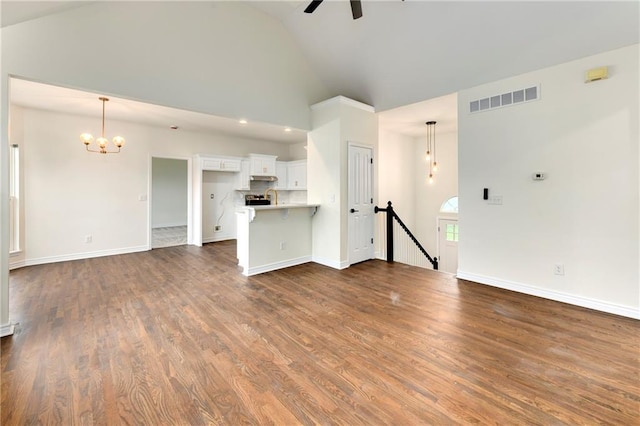 20105 Crestone St, Spring Hill, KS 66083 - unfurnished living room featuring a ceiling fan, a chandelier, dark wood finished floors, baseboards, and high vaulted ceiling