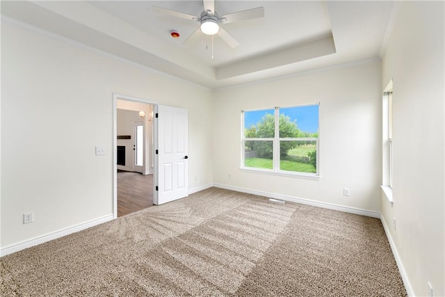 20105 Crestone St, Spring Hill, KS 66083 - carpeted empty room featuring a raised ceiling, baseboards, a ceiling fan, and crown molding