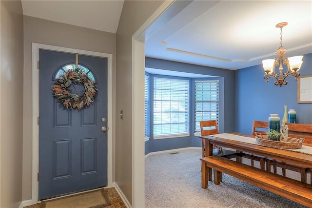 15005 W 94th St, Lenexa, KS 66215 - carpeted foyer featuring a chandelier and a tray ceiling