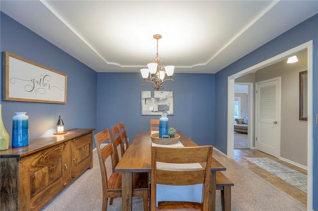 15005 W 94th St, Lenexa, KS 66215 - dining area featuring light colored carpet, a raised ceiling, and a chandelier