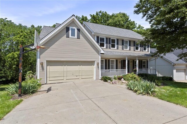 7642 N Atkins Pl, Kansas City, MO 64152 - view of front of property featuring a porch, concrete driveway, an attached garage, and a shingled roof