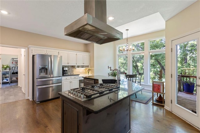 7642 N Atkins Pl, Kansas City, MO 64152 - kitchen featuring stainless steel appliances, island exhaust hood, white cabinetry, a center island, and a chandelier