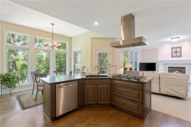 7642 N Atkins Pl, Kansas City, MO 64152 - kitchen featuring appliances with stainless steel finishes, ventilation hood, a chandelier, dark wood-type flooring, and pendant lighting