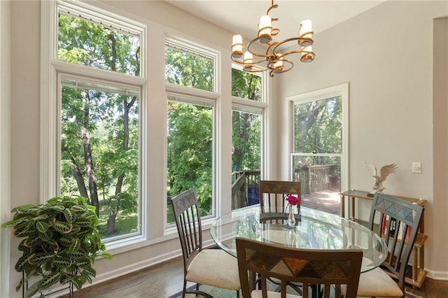 7642 N Atkins Pl, Kansas City, MO 64152 - dining area with a chandelier, dark wood finished floors, and plenty of natural light
