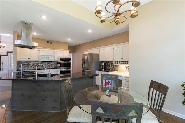 7642 N Atkins Pl, Kansas City, MO 64152 - dining area featuring a chandelier, wood finished floors, and recessed lighting