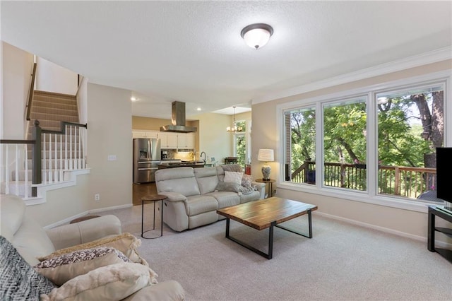 7642 N Atkins Pl, Kansas City, MO 64152 - living area with stairway, light colored carpet, crown molding, and a textured ceiling
