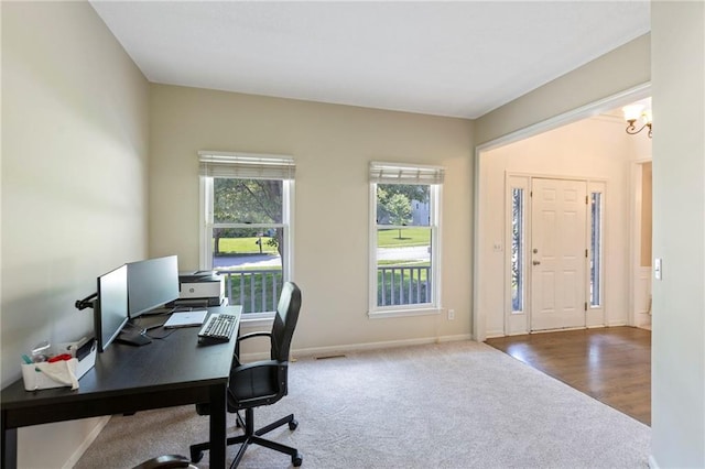 7642 N Atkins Pl, Kansas City, MO 64152 - carpeted office space featuring baseboards and a chandelier
