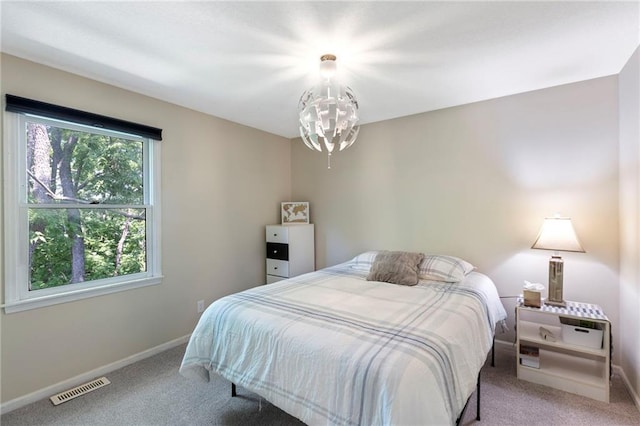 7642 N Atkins Pl, Kansas City, MO 64152 - carpeted bedroom with baseboards and a chandelier