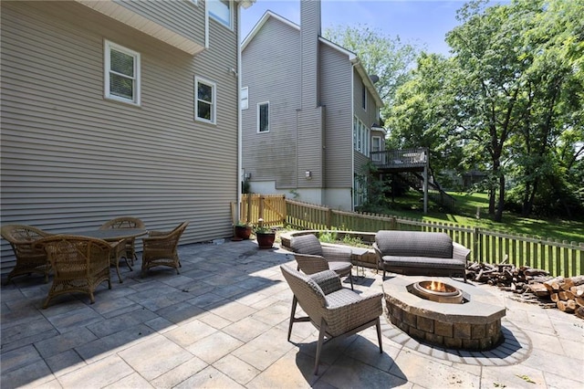 7642 N Atkins Pl, Kansas City, MO 64152 - fenced backyard with a fire pit and a patio area