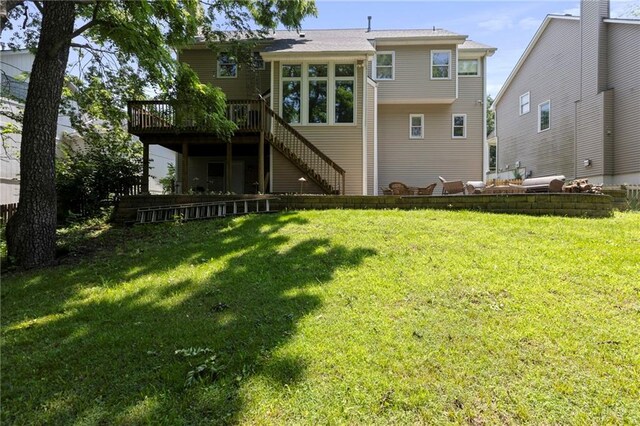 7642 N Atkins Pl, Kansas City, MO 64152 - back of house featuring stairway, a wooden deck, and a lawn