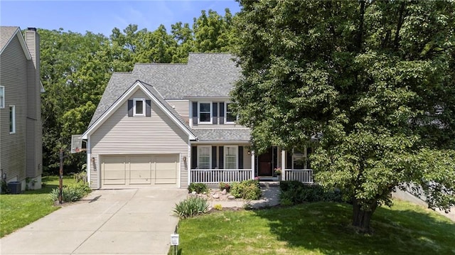 7642 N Atkins Pl, Kansas City, MO 64152 - view of front of house featuring covered porch, driveway, a front yard, and roof with shingles