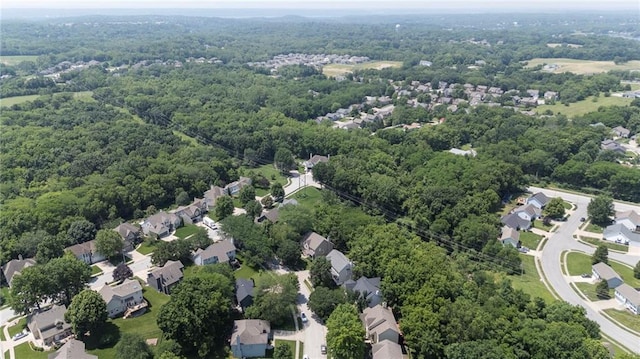 7642 N Atkins Pl, Kansas City, MO 64152 - aerial view of property and surrounding area featuring a heavily wooded area and nearby suburban area