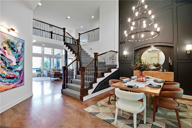 16821 Goddard St, Overland Park, KS 66221 - dining room featuring a towering ceiling, a chandelier, stairs, wood finished floors, and recessed lighting