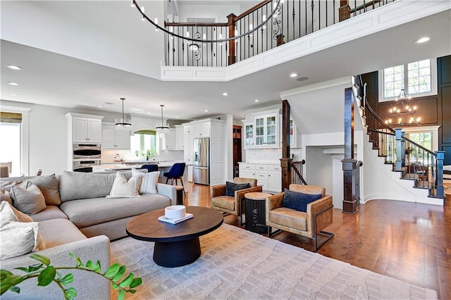 16821 Goddard St, Overland Park, KS 66221 - living area featuring a towering ceiling, a chandelier, stairway, wood finished floors, and recessed lighting
