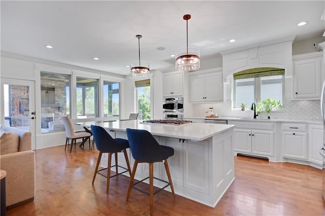 16821 Goddard St, Overland Park, KS 66221 - kitchen with a sink, a center island, backsplash, recessed lighting, and light countertops