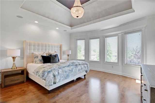 16821 Goddard St, Overland Park, KS 66221 - bedroom featuring a tray ceiling, a chandelier, wood finished floors, crown molding, and baseboards