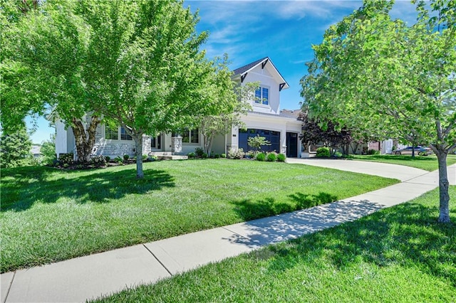 16821 Goddard St, Overland Park, KS 66221 - view of property hidden behind natural elements with a garage, concrete driveway, a front yard, and stone siding