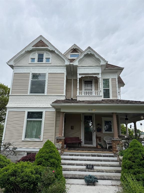 308 E Arrow St, Marshall, MO 65340 - victorian-style house with a porch and a balcony