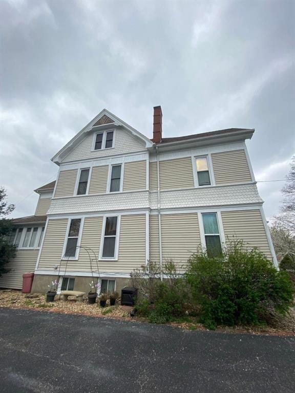 308 E Arrow St, Marshall, MO 65340 - view of property exterior with a chimney