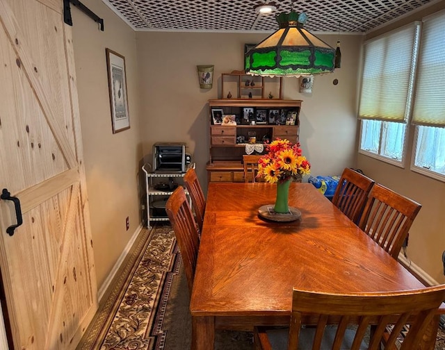 308 E Arrow St, Marshall, MO 65340 - dining space featuring a barn door and baseboards