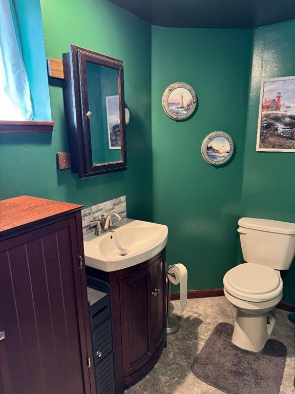 308 E Arrow St, Marshall, MO 65340 - bathroom featuring vanity, toilet, and baseboards