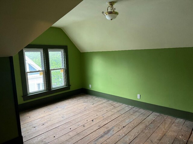 308 E Arrow St, Marshall, MO 65340 - bonus room featuring vaulted ceiling, hardwood / wood-style flooring, and baseboards